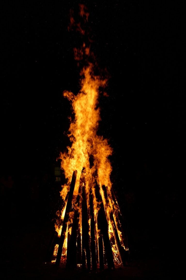 Embers glowing in a night camp