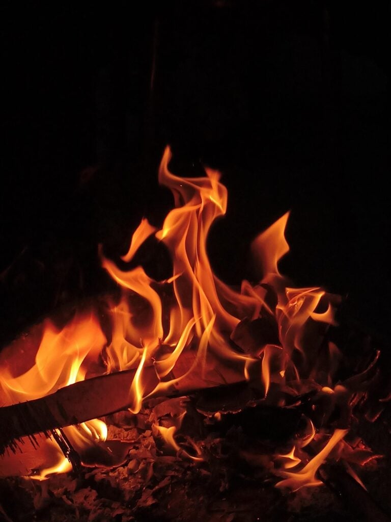 A campfire burning after dark