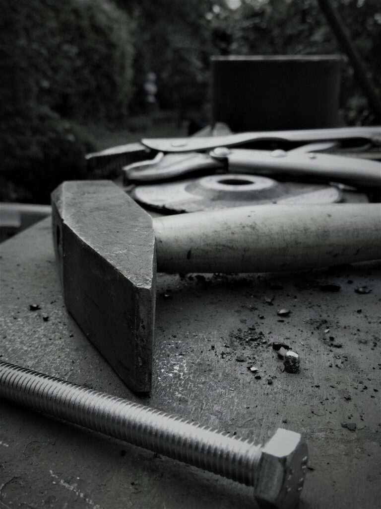Hands working with tools at a workbench