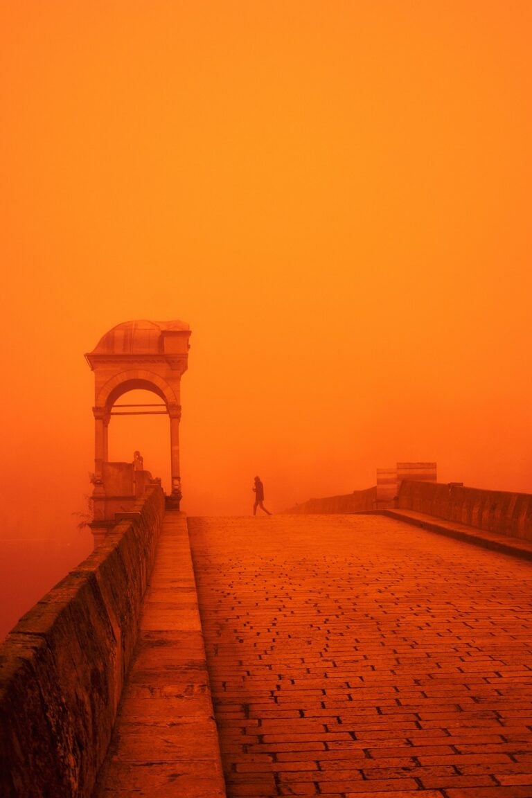 A man running on an open road at first light