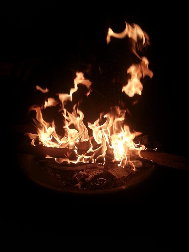 Embers glowing in a night camp