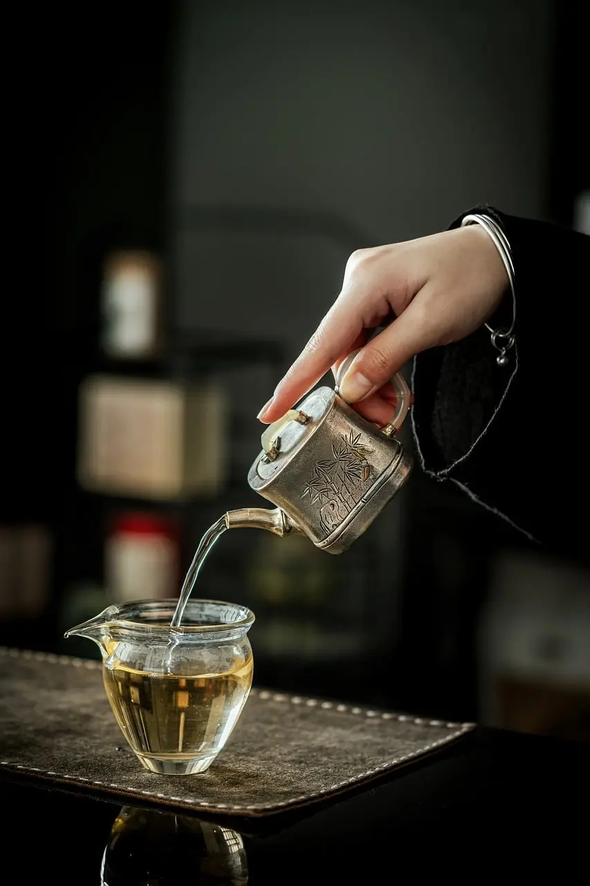 Water being poured into a glass, symbolizing filtering water to reduce PFAS exposure