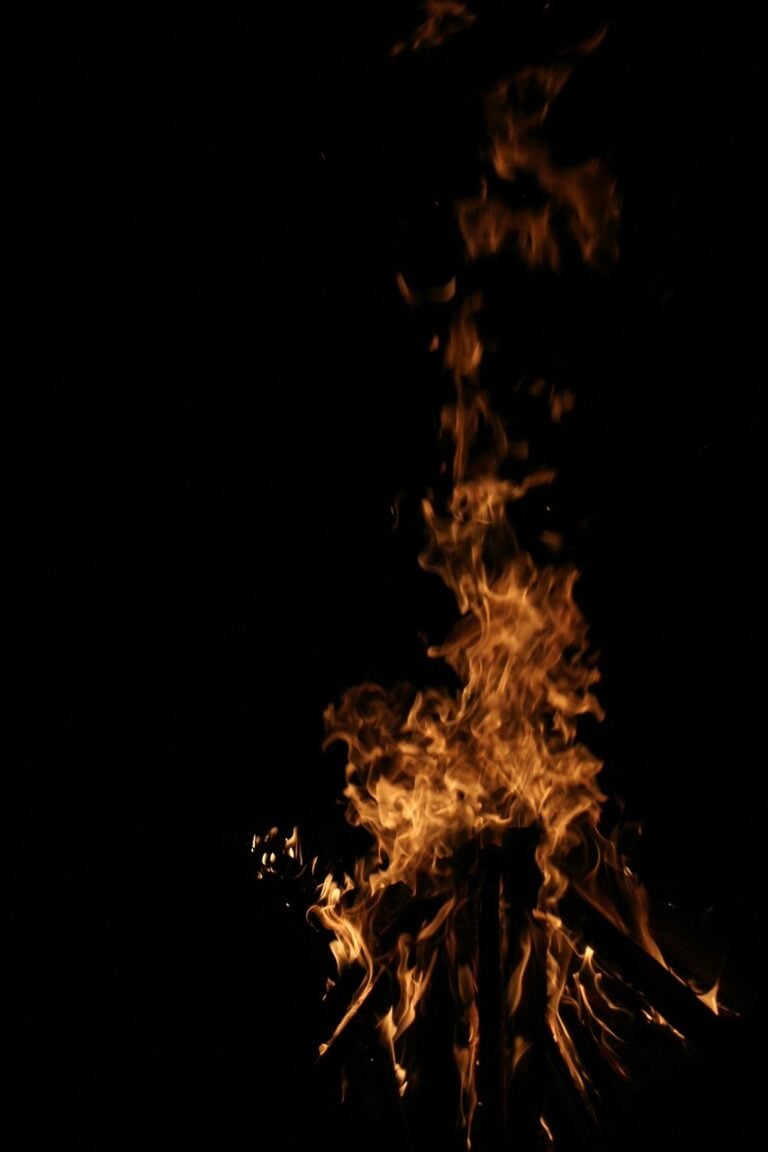 A campfire burning after dark
