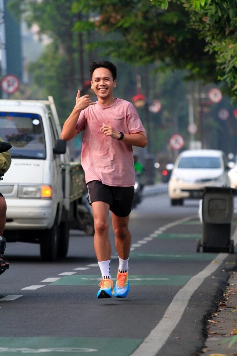 A runner on empty road before sunrise
