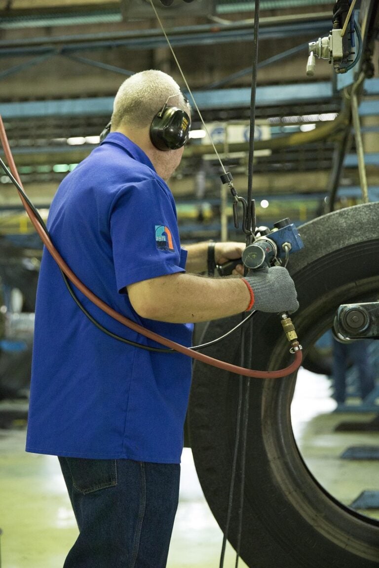 Hands working with tools at a workbench