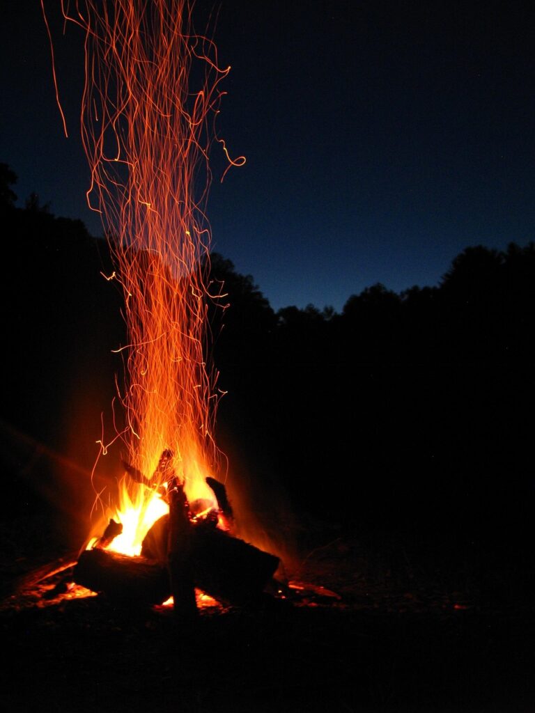 Embers glowing in a night camp