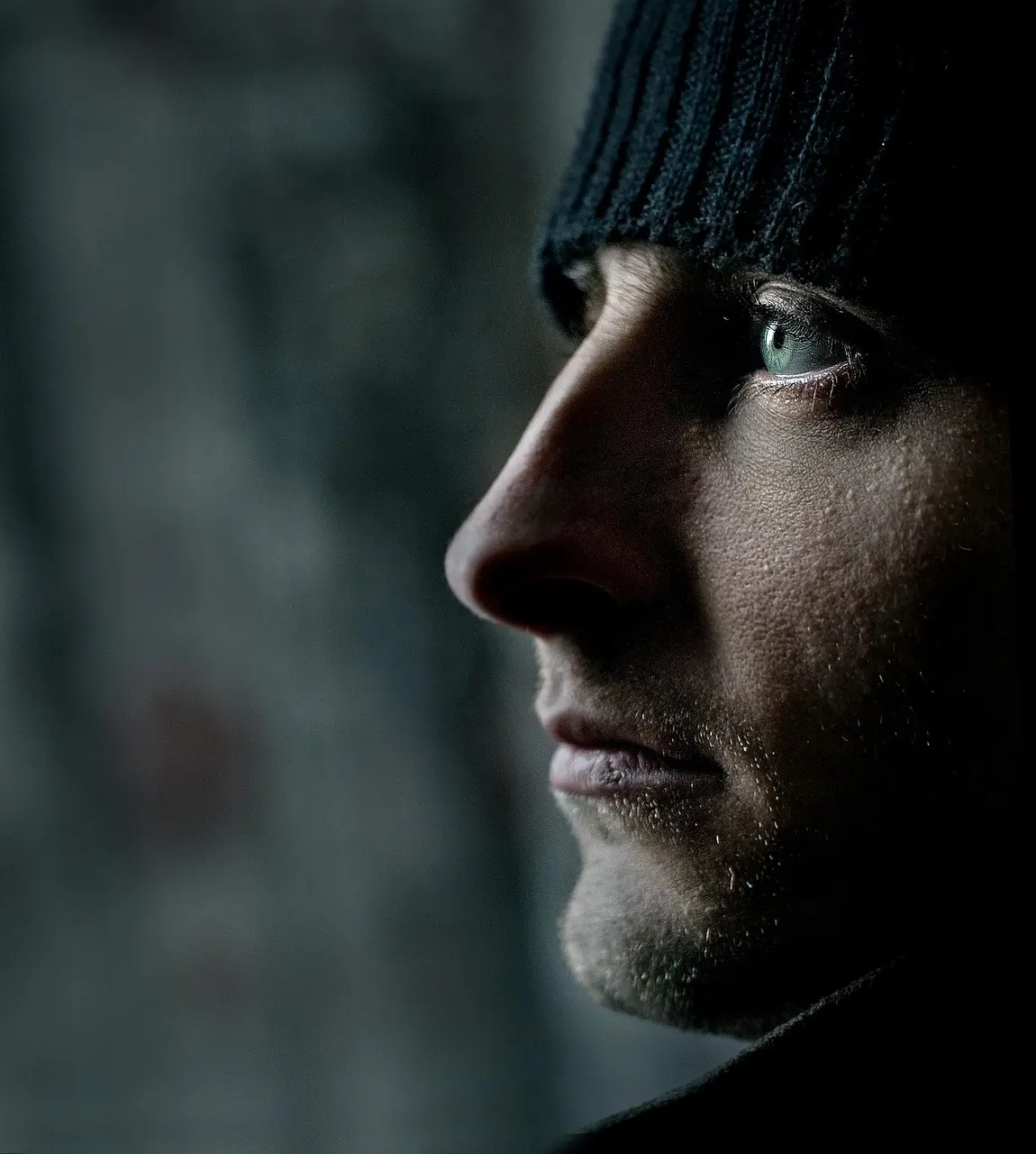 Close-up of a man's serious expression, symbolizing suppressed emotional release
