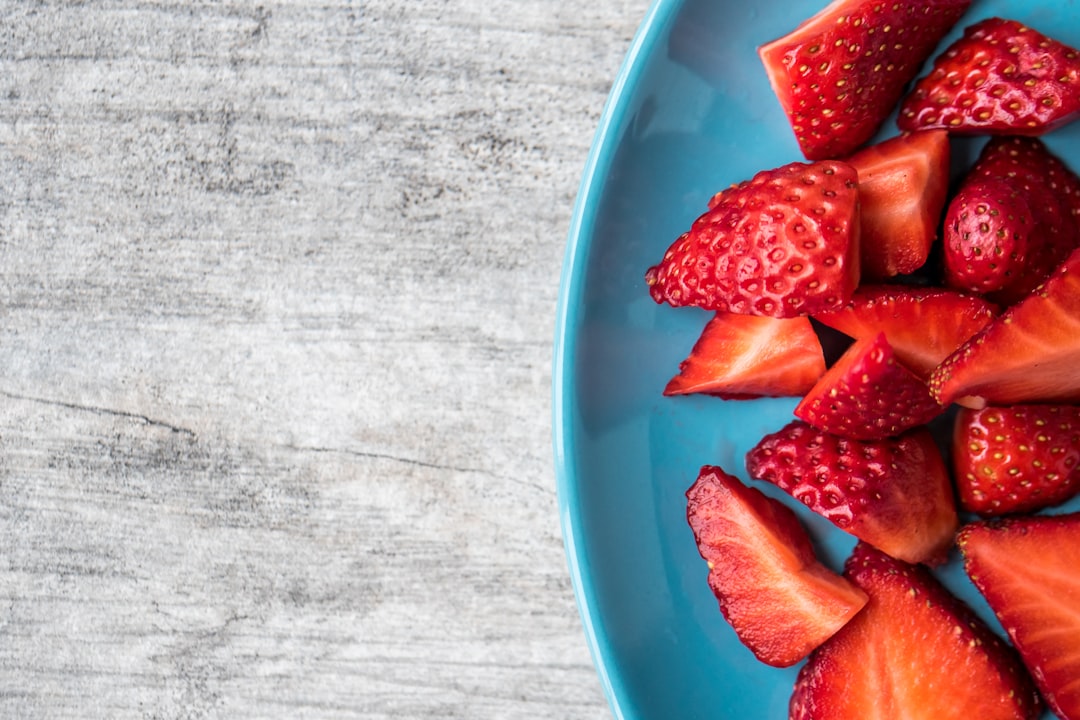 sliced strawberries on teal ceramic plate - Intermittent Fasting and Inflammation