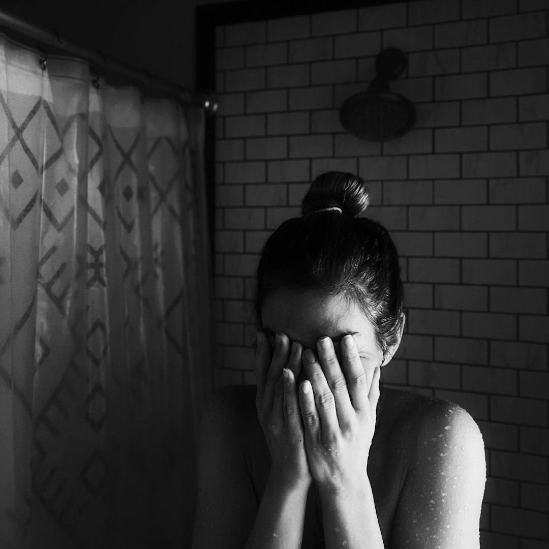 grayscale photo of woman covering her face with her hands - Mastering Stress