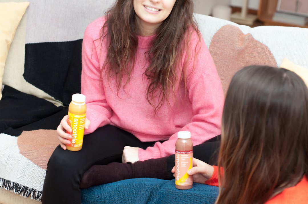 two women holding smoothie bottles - The Impact of Toxins