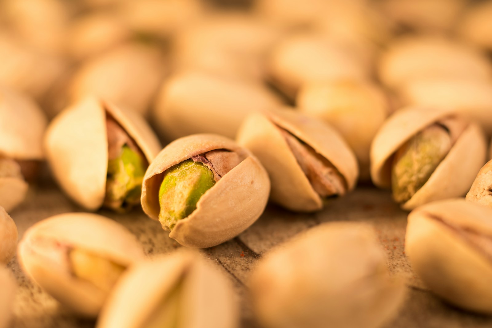 a pile of pistachio nuts sitting on top of a table Nutritional