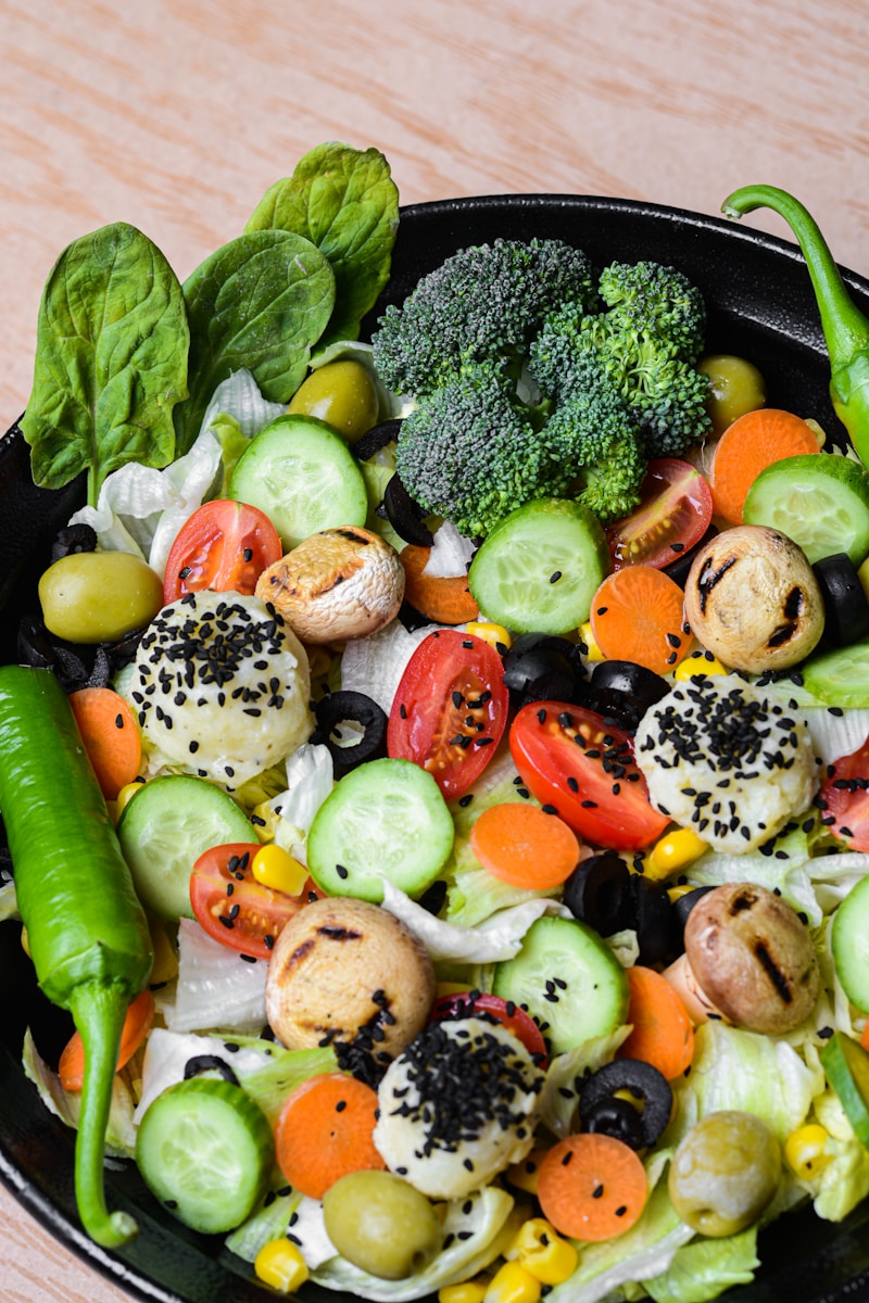 a black bowl filled with vegetables on top of a wooden table foods for better sleep”