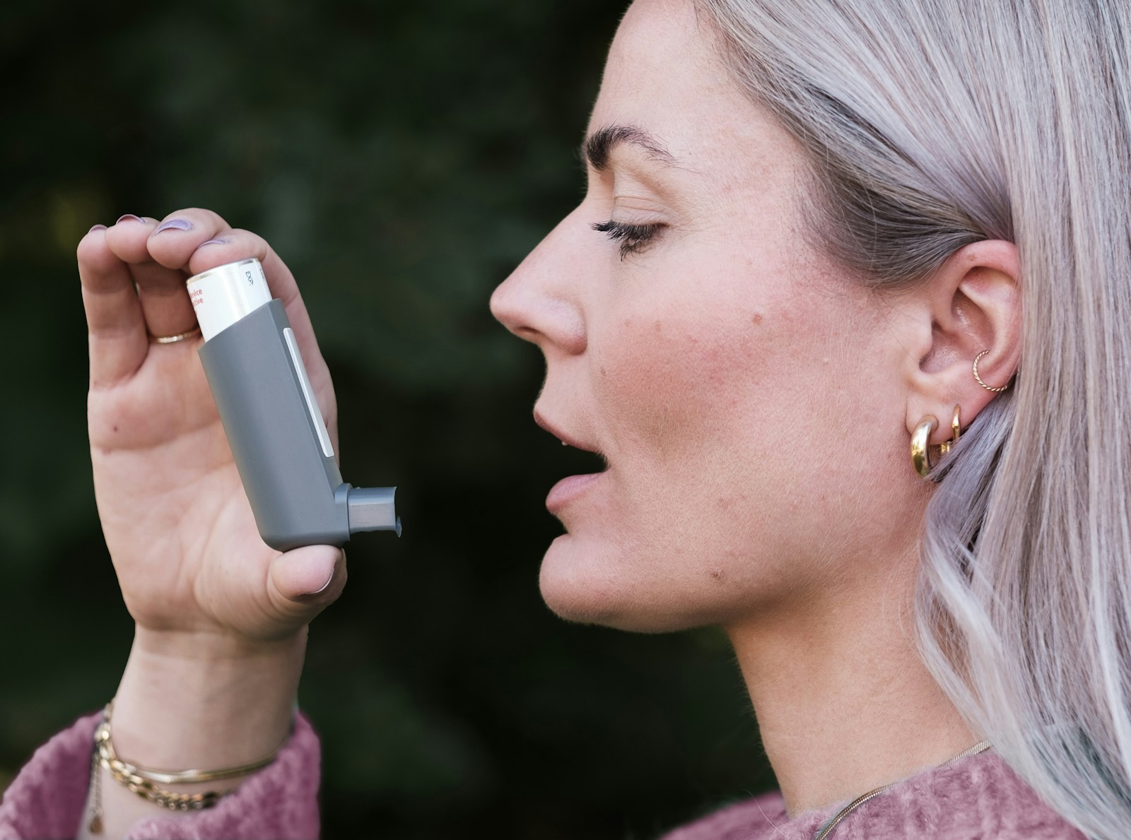 A woman holding a cell phone up to her face