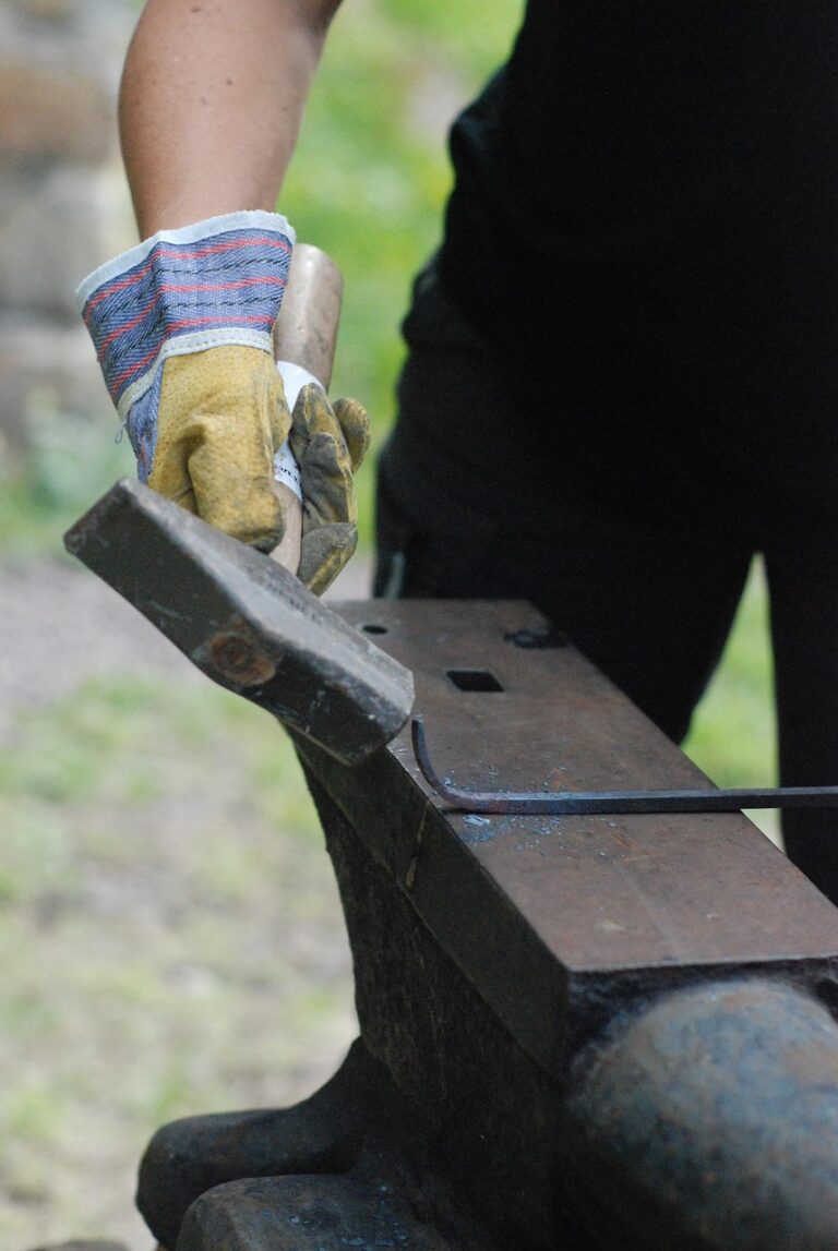 A smith shaping iron by hand