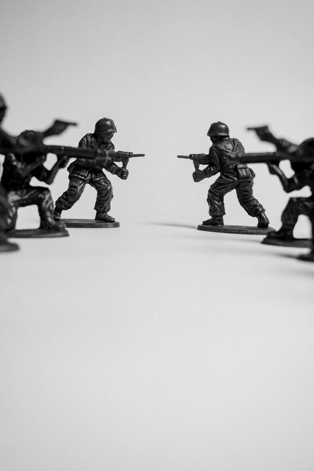 Toy soldiers in battle formation on a white background