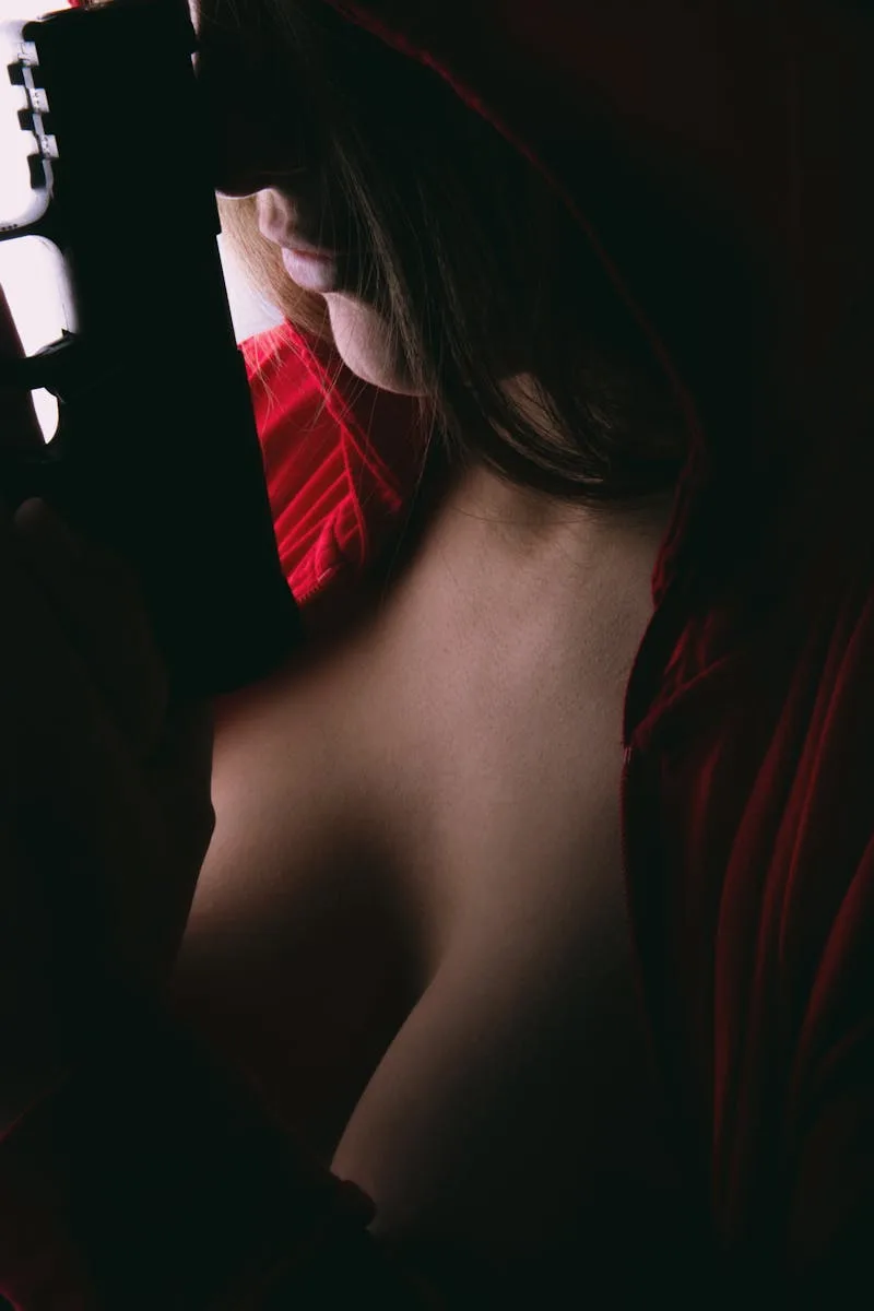 A dramatic close-up of a woman holding a handgun in low light, creating a