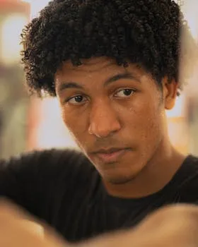 Portrait of a determined athlete with focused gaze captured in a gym