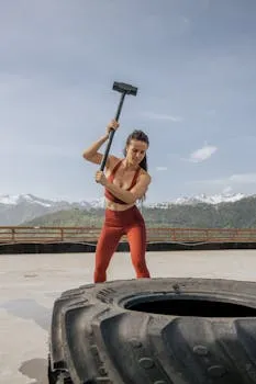 Woman in intense athletic training set against dramatic mountain backdrop