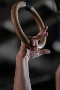 Detailed shot of an athlete's hand holding a gymnastics ring, highlighting