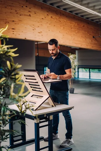 man at standing desk working with disciplined focus