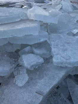 A detailed view of layered ice fragments showcasing winter's frozen beauty.