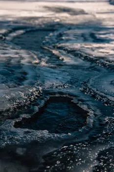 Detailed photograph capturing unique ice formations on a frozen water