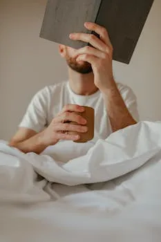 A serene morning scene of a man drinking coffee and reading in bed, creating