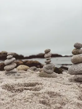 Peaceful stacks of stones on a sandy beach in Pacific Grove, CA, capturing