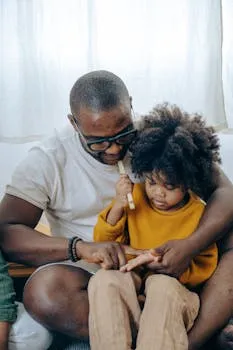 A father attentively teaching his child at home, showcasing a strong bond