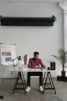 Architect working at desk demonstrating integrated approach to leadership