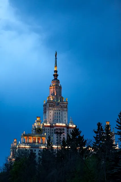 University building at night illuminated against dark sky, representing