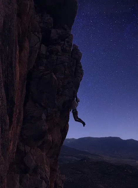 mountaineer at sunrise on a high ridge, perseverance and purpose, climbing