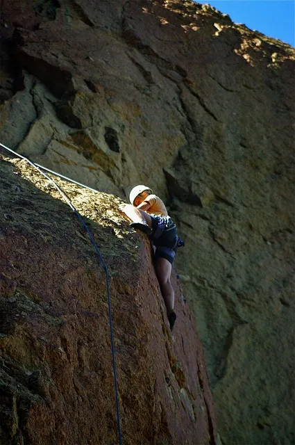 rock climber on a sheer face, man persevering against difficult terrain,