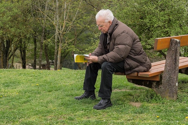 A man's morning routine laid out on a minimal desk: journal, water, running