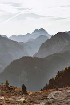 Rocky mountain ridgeline at dawn, layered peaks extending to the horizon.