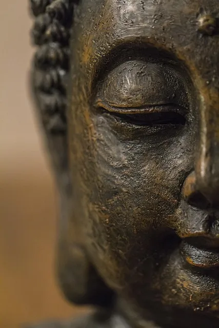 ancient stone Buddha statue in contemplative pose