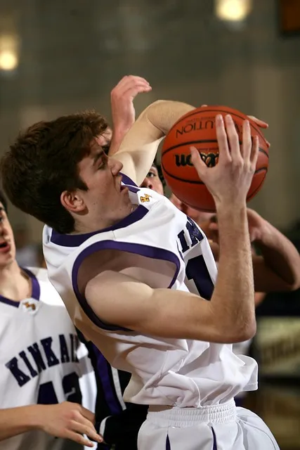 Two basketball players competing in a physical contest