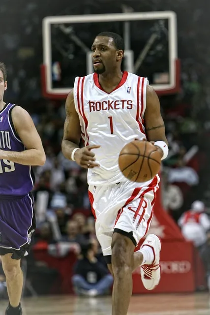Basketball player in competitive action, executing under pressure