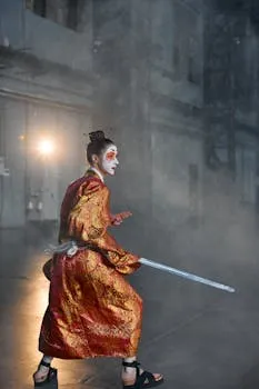 A woman in a vibrant kimono poses with a sword, embodying a warrior spirit