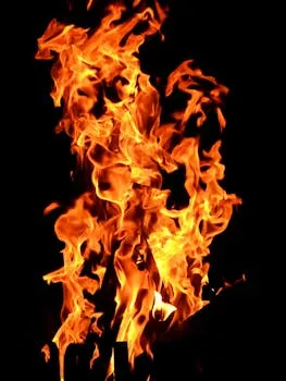 Close-up fiery blaze with vibrant orange flames creating a dynamic pattern