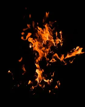 Captivating image of flames flickering vividly against a dark backdrop,