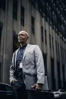 A confident, well-dressed businessman looking away with a thoughtful
