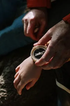 A touching moment of exploration with a parent guiding a child using a compass.