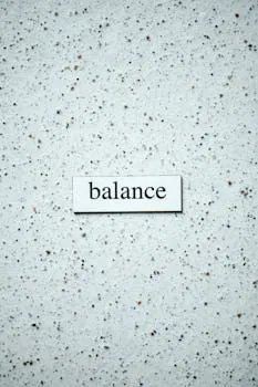 Minimalist image featuring the word 'balance' on a speckled textured wall