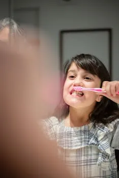 Young girl practicing daily oral hygiene by brushing her teeth indoors,