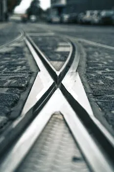 Close-up view of railway tracks converging on a cobblestone street.