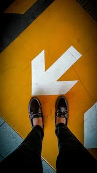 Fashionable leather shoes standing on a bright arrowed floor, making a style