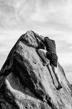 Man bouldering on rocky cliffs, the physical expression of raw persistence
