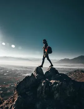 Lone hiker in high mountain terrain — perseverance operating at altitude