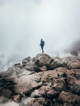 Hiker alone in mountain fog — where persistence meets its limits